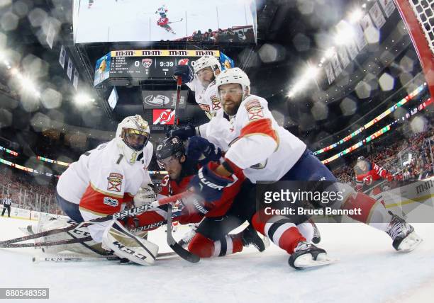 Roberto Luongo and Aaron Ekblad of the Florida Panthers defend the net against Stefan Noesen of the New Jersey Devils during the first period at the...