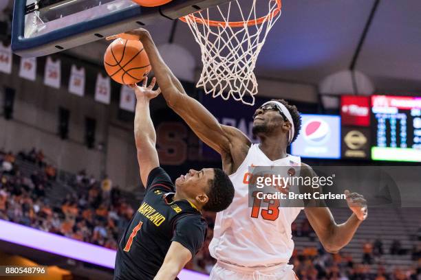 Paschal Chukwu of the Syracuse Orange blocks a shot by Anthony Cowan of the Maryland Terrapins during the first half at the Carrier Dome on November...