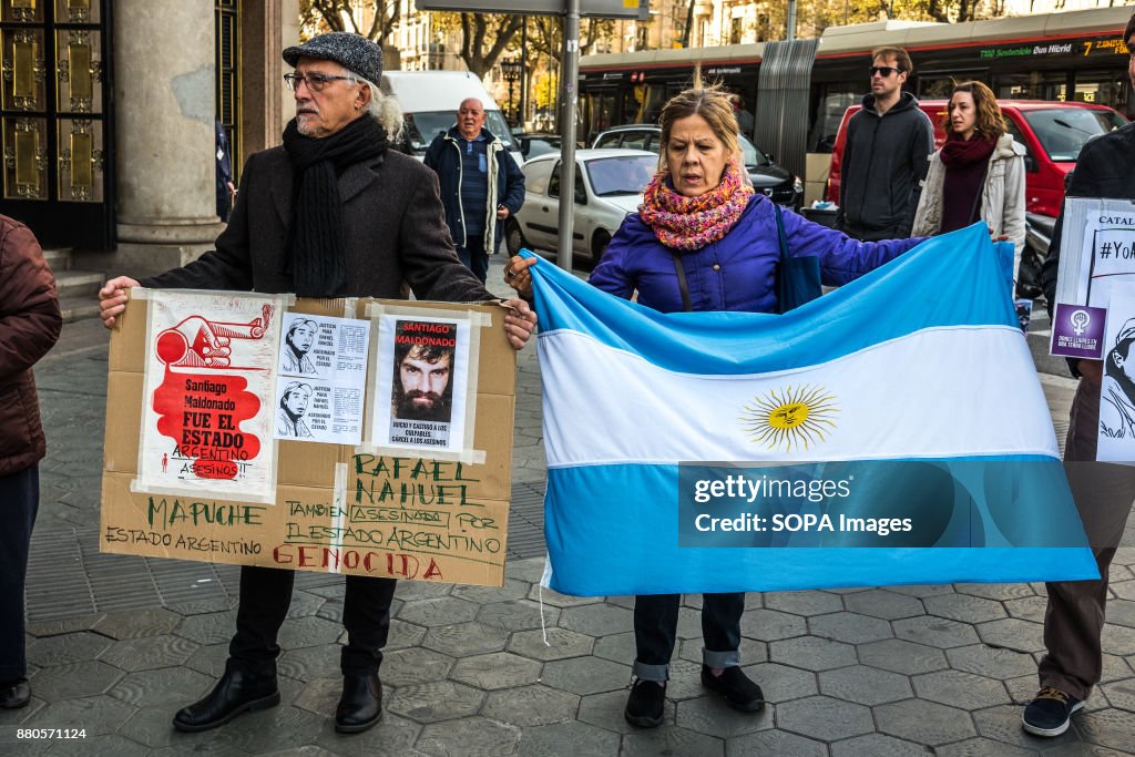 Two demonstrators displayed posters and an Argentinean flag...