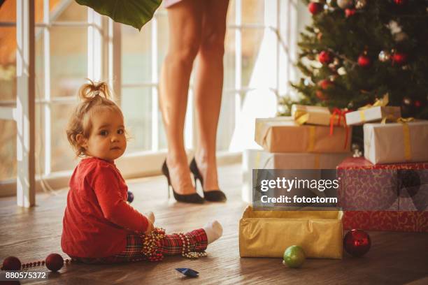 baby decorating christmas tree with mom - girl with legs open stock pictures, royalty-free photos & images