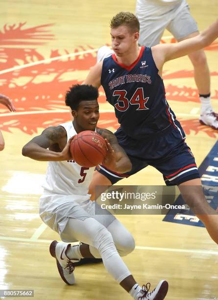 Jock Landale of the St. Mary's Gaels guards Rio Haskett of the Harvard Crimson during the game at the Titan Gym on November 23, 2017 in Fullerton,...