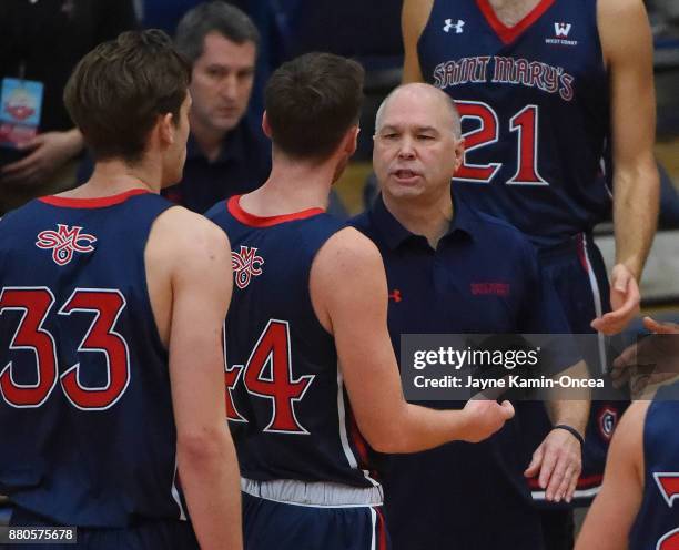 Head coach Randy Bennett of the St. Mary's Gaels talks to his team during a time out in the game against the Harvard Crimson at the Titan Gym on...