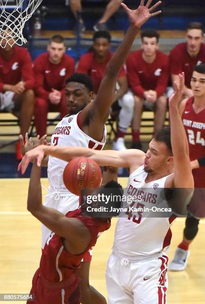 Nick Robinson of the Saint Joseph's Hawks gets a shot blocked by Drick Bernstine and Robert Franks of the Washington State Cougars during the game at...