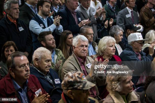 Judge Roy Moore supporters listen during a campaign rally on November 27, 2017 in Henagar, Alabama. Over 100 people turned out to the event packing...
