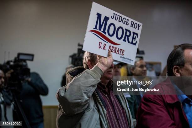 Judge Roy Moore supporters listen during a campaign rally on November 27, 2017 in Henagar, Alabama. Over 100 people turned out to the event packing...