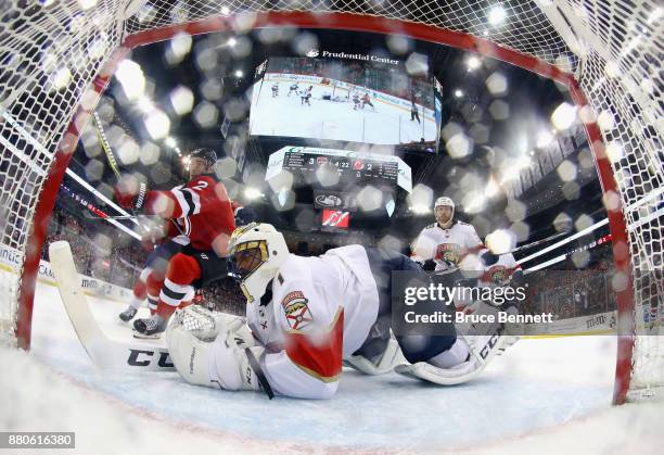 John Moore of the New Jersey Devils misses a third period chance against Roberto Luongo of the Florida Panthers at the Prudential Center on November...