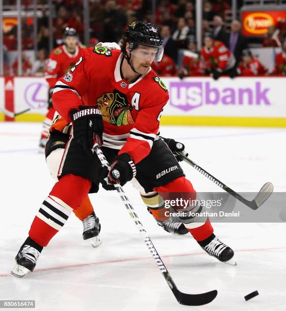 Duncan Keith of the Chicago Blackhawks chases down the puck in front of Logan Shaw of the Anaheim Ducks at the United Center on November 27, 2017 in...