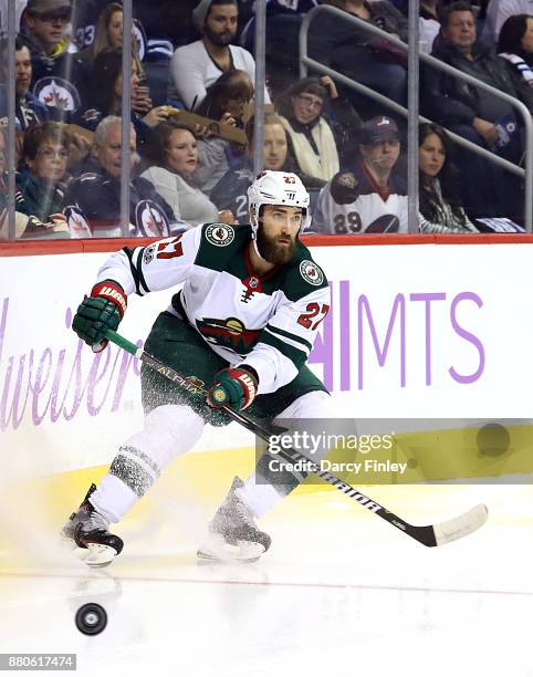 Kyle Quincey of the Minnesota Wild plays the puck during first period action against the Winnipeg Jets at the Bell MTS Place on November 27, 2017 in...