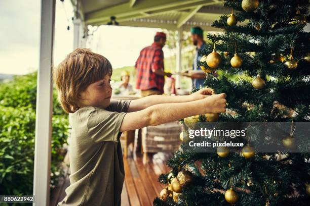 putting the finishing touches on the christmas tree - christmas australia stock pictures, royalty-free photos & images