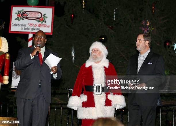 Newy Scruggs, KXAS-TV Sports Director, Santa Claus, and Texas Motor Speedway President Eddie Gossage prepare to light the tree at the Speedway...