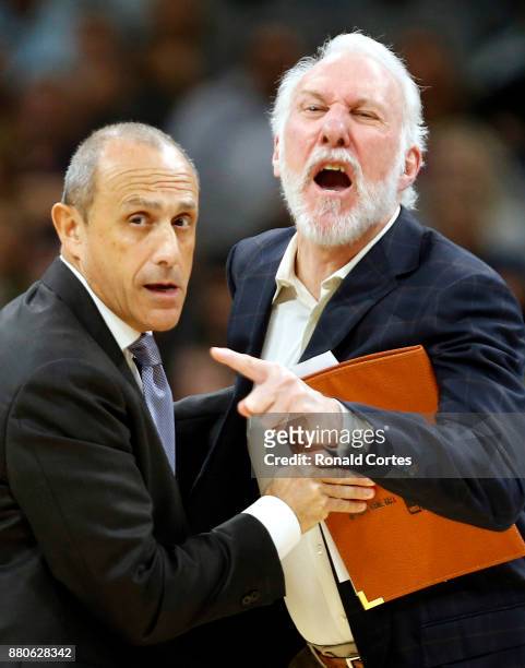 Gregg Popovich head coach of the San Antonio Spurs is restrained by assistant coach Ettore Messina after receiving his second technical during game...