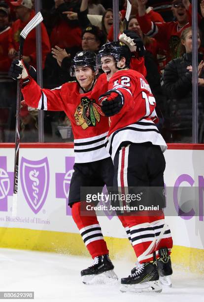 Patrick Kane and Alex DeBrincat of the Chicago Blackhawks celebrate DeBrincat's third goal of the game in the second period against the Anaheim Ducks...
