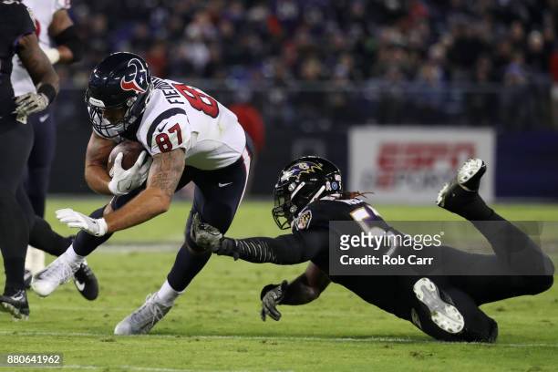 Tight End C.J. Fiedorowicz of the Houston Texans is tackled by inside linebacker C.J. Mosley of the Baltimore Ravens in the second quarter at M&T...