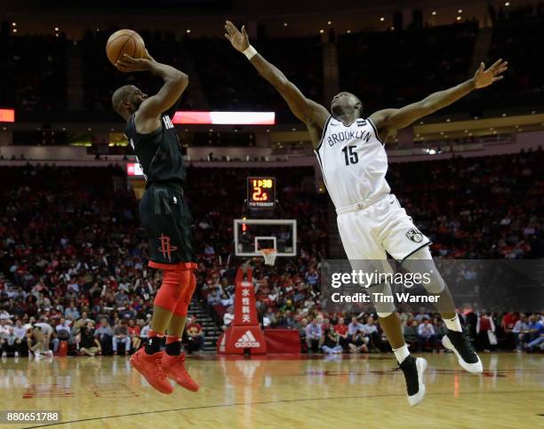 Chris Paul of the Houston Rockets takes a shot defended by Isaiah Whitehead of the Brooklyn Nets in the second half at Toyota Center on November 27,...