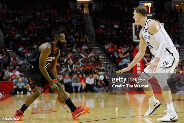 James Harden of the Houston Rockets controls the ball defended by Timofey Mozgov of the Brooklyn Nets in the second half at Toyota Center on November...