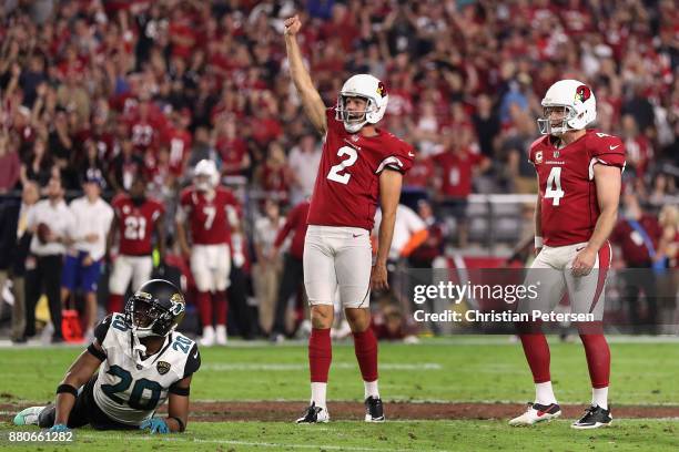 Holder Andy Lee and kicker Phil Dawson of the Arizona Cardinals celebrate after Dawson scores a 57 yard game winning field goal against the...