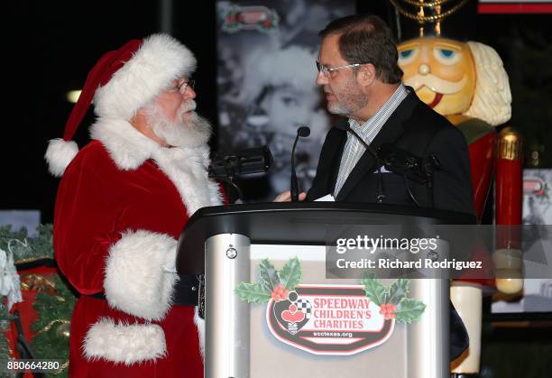 Santa Claus visits with Texas motor Speedway President Eddie Gossage at the Speedway Children's Charities-Texas Chapter Grant Ceremony and Tree...