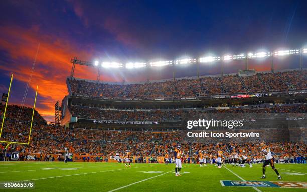 Brilliant blue and orange sunset over the stadium a during a game against the Cincinnati Bengals and Denver Broncos at Sports Authority Field at Mile...