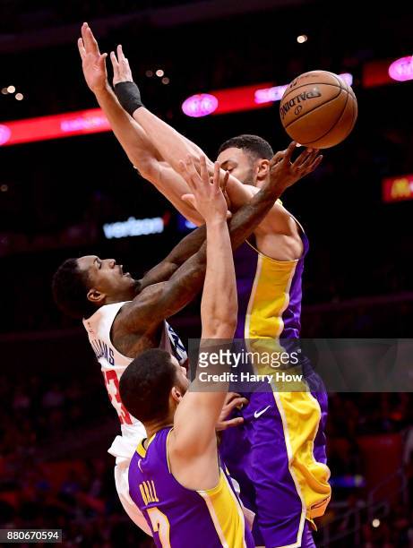 Lou Williams of the LA Clippers scores on Larry Nance Jr. #7 and Lonzo Ball of the Los Angeles Lakers during the second quarter in a 120-115 Clipper...