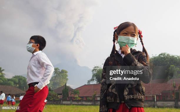 Elementary school students with face masks are seen in a school ground before school in Rendang village of Karangasem, Bali, Indonesia on November...