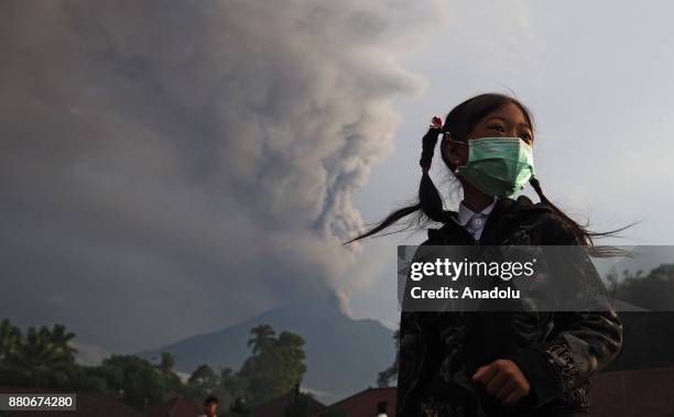 An elementary school student with a face mask is seen in a school ground before school in Rendang village of Karangasem, Bali, Indonesia on November...