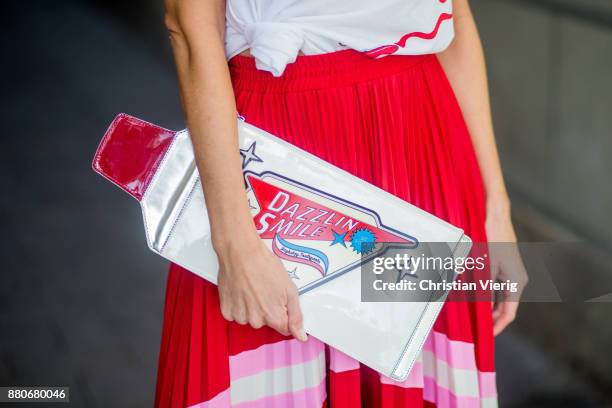 Alexandra Lapp wearing a pleated skirt from Valentino, white t-shirt from Valentino with label print written over the chest with red lipstick, high...