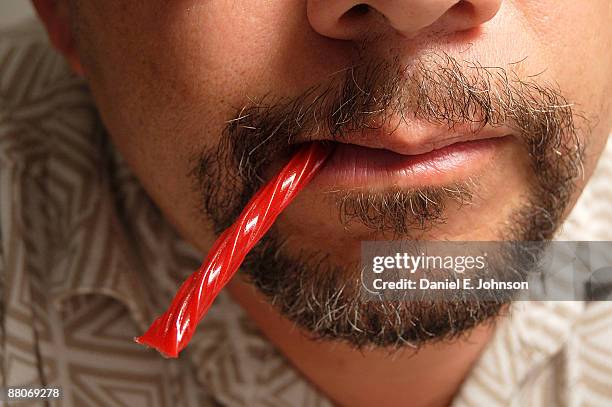 licorice on the lips - licorice stock pictures, royalty-free photos & images