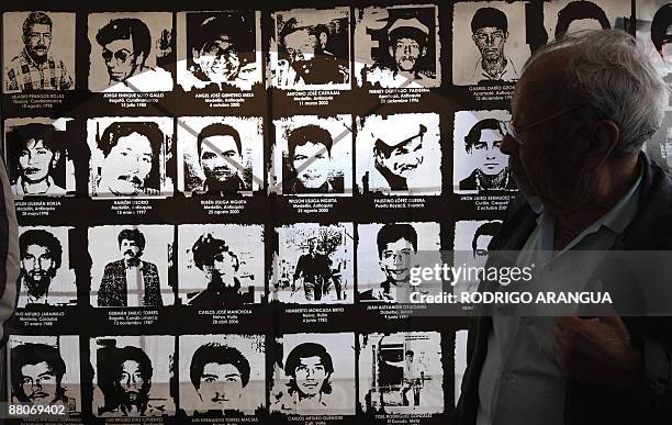 Man looks at pictures of people who allegedly went missing by actions of the Colombian security forces, at Bolivar Square in Bogota on May 29, 2009....