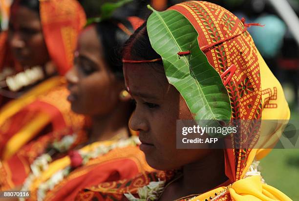 Indian brides and grooms from the Adivasi tribe take part in a mass marriage ceremony during a religious conference in Salbari village on the...