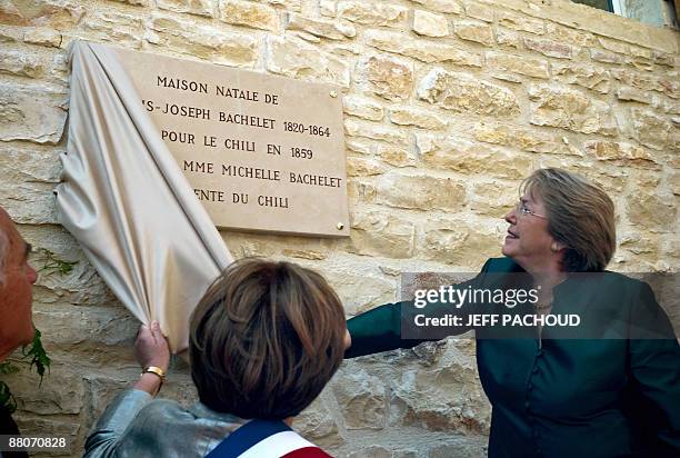 French mayor of the eastern town of Chassagne-Montrachet, Francoise Moreau and Chilean president Michelle Bachelet unveil a tablet fixed up on the...