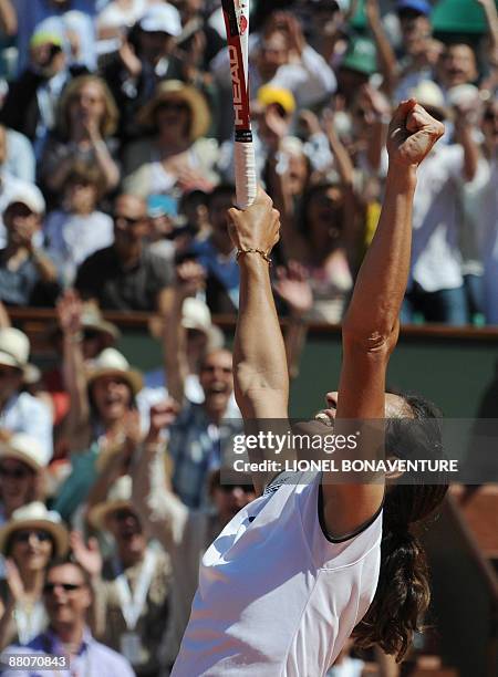 France's Virginie Razzano celebrates after winning against Italy's Tathiana Garbin during their French Open tennis third round match on May 30, 2009...