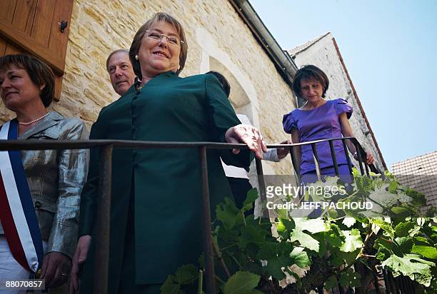French mayor of the eastern town of Chassagne-Montrachet, Francoise Moreau and Chilean president Michelle Bachelet leave the house of Bachelet's...