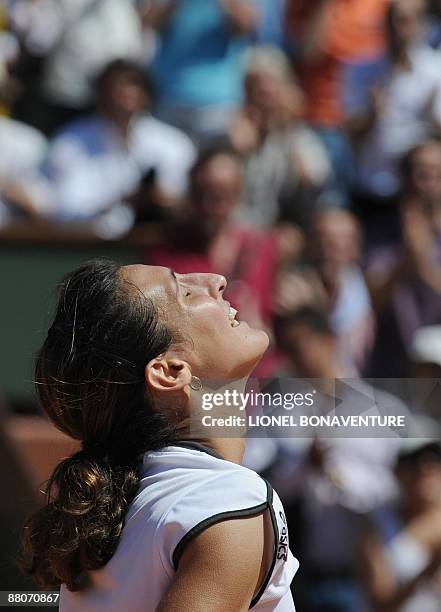 France's Virginie Razzano celebrates after winning against Italy's Tathiana Garbin during their French Open tennis third round match on May 30, 2009...