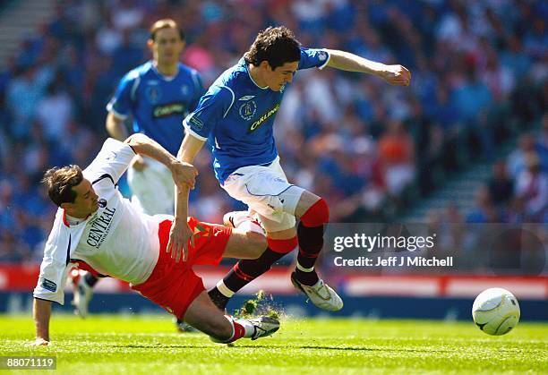 Kyle Lafferty of Rangers is tackled by Jackie McNamara of Falkirk during the Scottish FA Cup Final match between Rangers and Falkirk at Hampden Park...