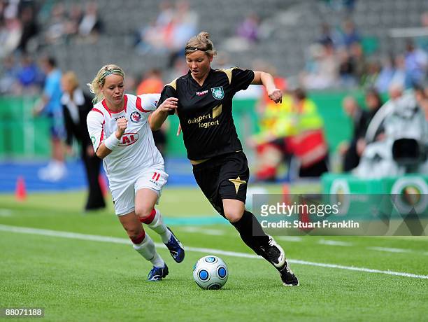 Leni Larsen Kaurin of Potsdam challenges Alexandra Popp of Dusiburg during the Women's DFB Cup Final match between FCR Duisburg and Turbine Potsdam...