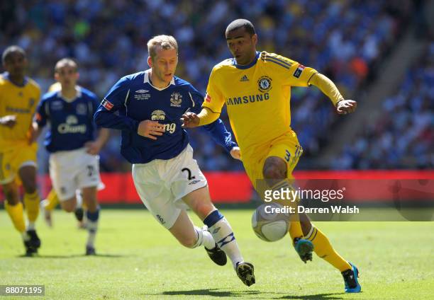 Ashley Cole of Chelsea is challenged by Tony Hibbert of Everton during the FA Cup sponsored by E.ON Final match between Chelsea and Everton at...
