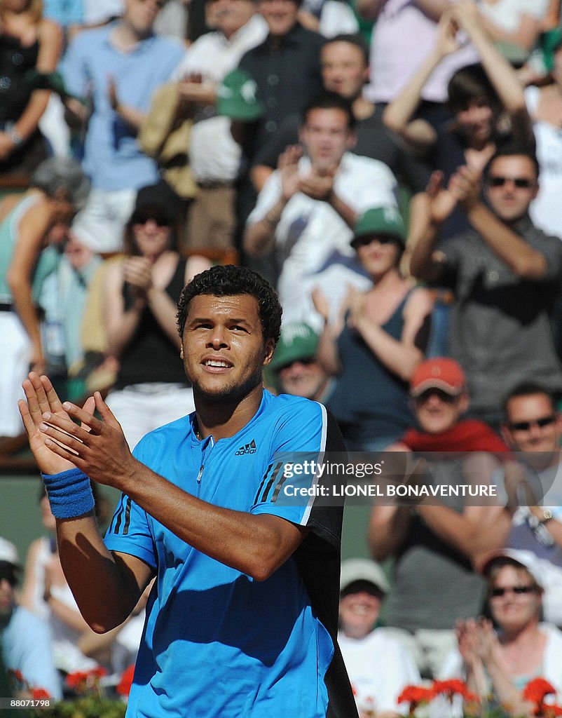 French player Jo-Wilfried Tsonga claps a