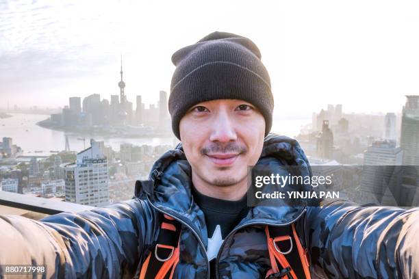 selfie portrait on rooftop shanghai china - chinese culture stock-fotos und bilder