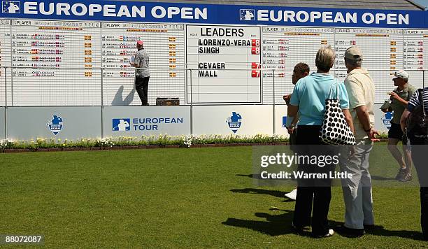 Fans keep an eye on the leader board during the third round of The European Open at the London Golf Club on May 30, 2009 in Ash, England.