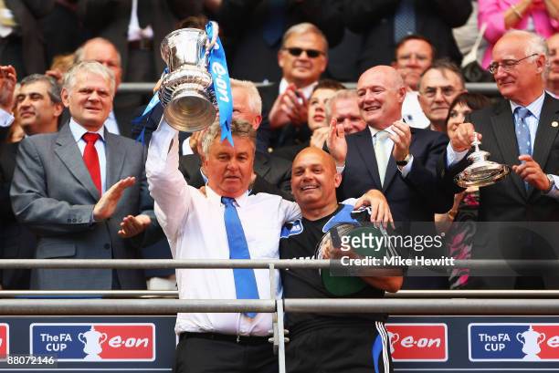 Chelsea manager Guus Hiddink lifts the trophy assistant Ray Wilkins following victory during the FA Cup sponsored by E.ON Final match between Chelsea...