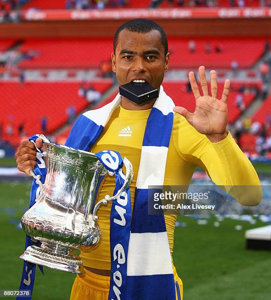 Ashley Cole of Chelsea lifts the trophy after winning his fifth medal during the FA Cup sponsored by E.ON Final match between Chelsea and Everton at...