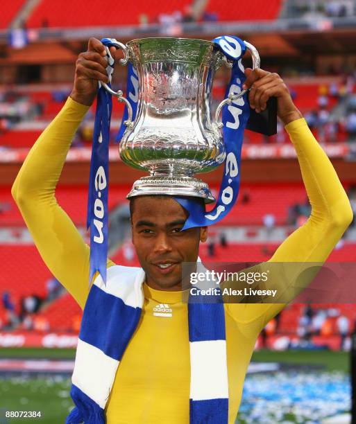 Ashley Cole of Chelsea lifts the trophy after winning his fifth medal during the FA Cup sponsored by E.ON Final match between Chelsea and Everton at...