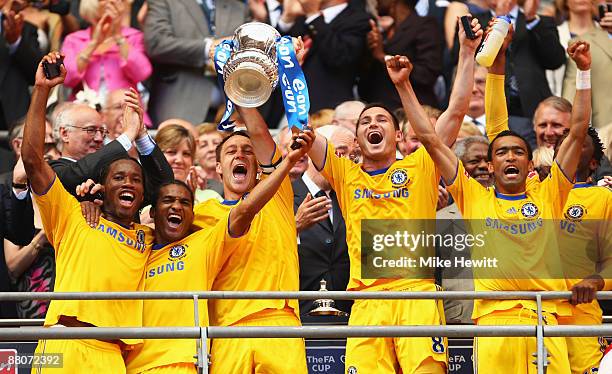 Captain John Terry of Chelsea lifts the trophy with Frank Lampard following victory during the FA Cup sponsored by E.ON Final match between Chelsea...