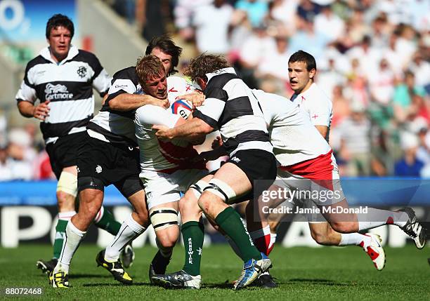 Chris Robshaw of England is challenged by Schalk Brits and Jerry Collins of the Barbarians during the match between England and the Barbarians at...