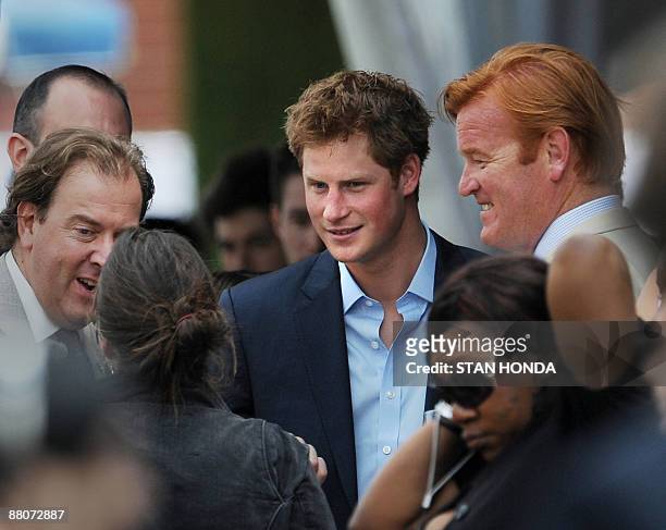 Prince Harry talks with guests before playing in the second annual Veuve Clicquot Manhattan Polo Classic May 30, 2009 on Governors Island at the...