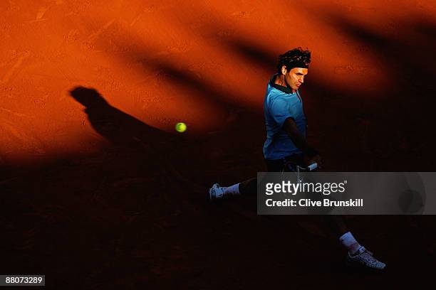 Roger Federer of Switzerland hits a backhand during the Men's Third Round match against Paul-Henri Mathieu of France on day seven of the French Open...