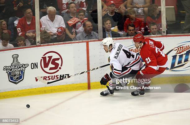 Niklas Hjalmarsson of the Chicago Blackhawks skates after the puck against Ville Leino of the Detroit Red Wings during Game Five of the Western...