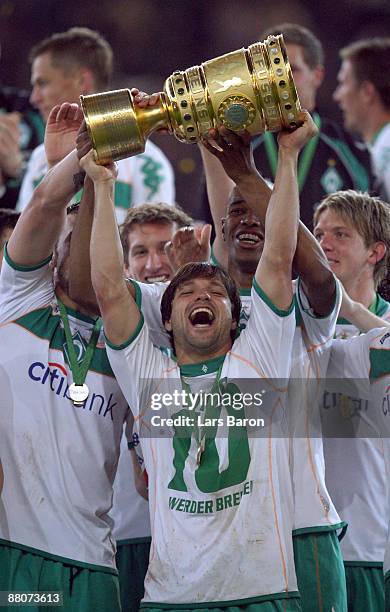 Diego of Bremen lifts the trophy after winning the DFB Cup Final match between Bayer 04 Leverkusen and SV Werder Bremen at Olympic Stadium on May 30,...