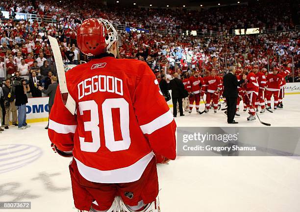 Chris Osgood of the Detroit Red Wings skates towards his teammates as they celebrate their 2-1 overtime win against the Chicago Blackhawks during...