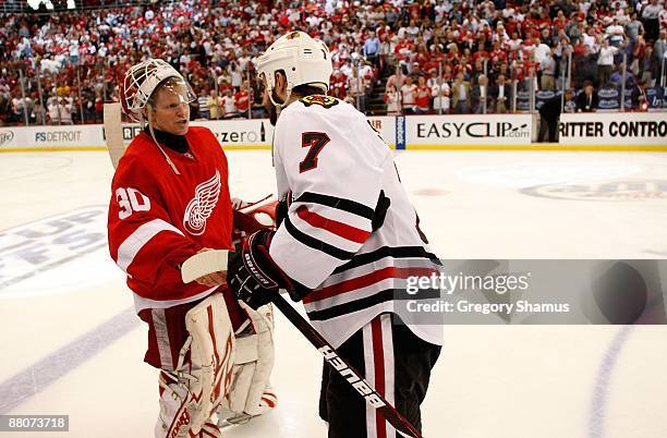 Goalie Chris Osgood of the Detroit Red Wings is congratulated by Brent Seabrook of the Chicago Blackhawks after the Red Wings won 2-1 in overtime...